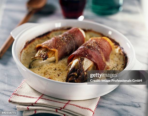 baked chicory with ham - endive stock pictures, royalty-free photos & images