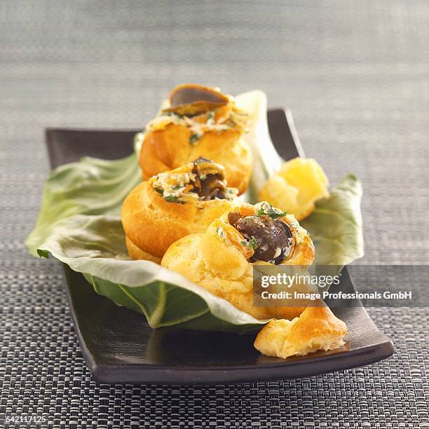 puff pastries filled with snails from bourgogne - eclairs stock pictures, royalty-free photos & images