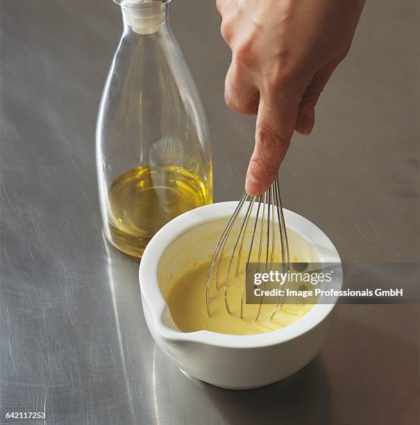 adding olive oil and whip - hand holding whisk stock pictures, royalty-free photos & images