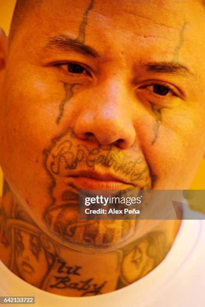 Prisoner, member of the "Barrio 18 Revolucionarios" gang gestures at the San Francisco Gotera Prison on February 16, 2017 in Morazan, El Salvador....