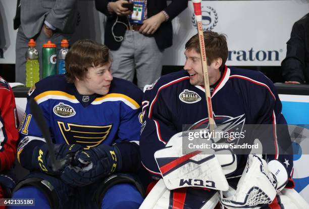 Vladimir Tarasenko of the St. Louis Blues and Sergei Bobrovsky of the Columbus Blue Jackets talk on the bench during the 2017 Coors Light NHL...