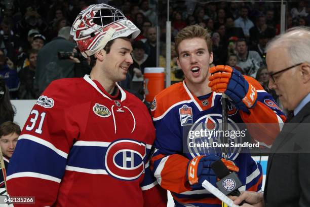 Carey Price of the Montreal Canadiens and Connor McDavid of the Edmonton Oilers talk near the bench area during the 2017 Coors Light NHL All-Star...