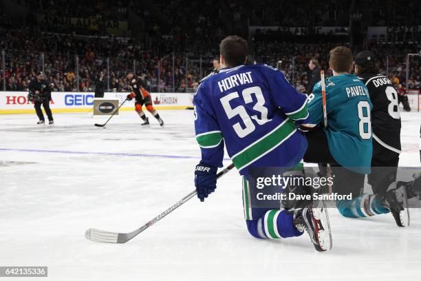 Bo Horvat of the Vancouver Canucks, Joe Pavelski of the San Jose Sharks and Drew Doughty of the Los Angeles Kings watch Cam Fowler of the Anaheim...