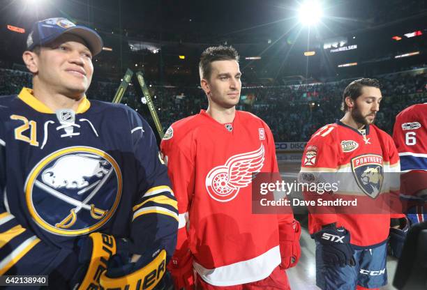 Kyle Okposo of the Buffalo Sabres, Frans Nielsen of the Detroit Red Wings and Vincent Trocheck of the Florida Panthers look on during player...