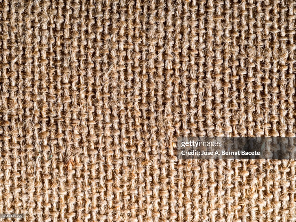 Full frame of the textures and colors of a fabric of burlap of brown color
