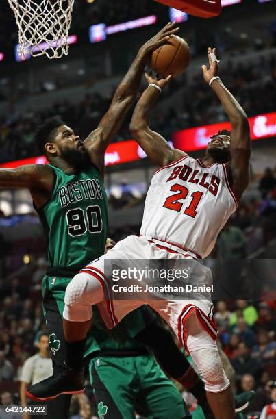 Amir Johnson of the Boston Celtics blocks a shot attempt by Jimmy Butler of the Chicago Bulls at the United Center on February 16, 2017 in Chicago,...
