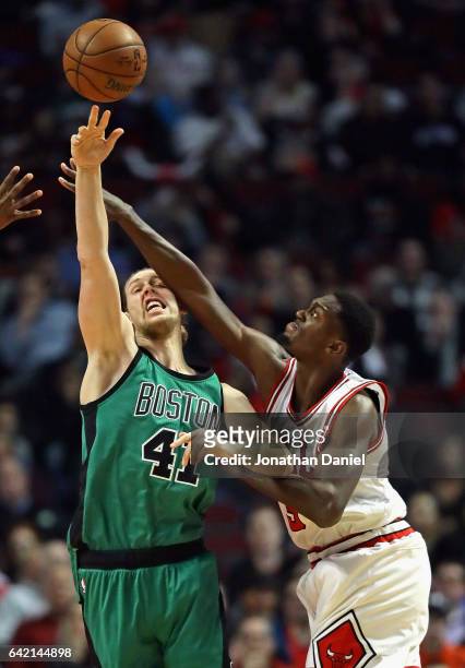 Kelly Olynyk of the Boston Celtics gets off a pass under presure from Bobby Portis of the Chicago Bulls at the United Center on February 16, 2017 in...