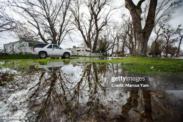 Water broke through the levee to flood parts of the Pacific Heights road along the Feather River as it continues to swell from the water being let...