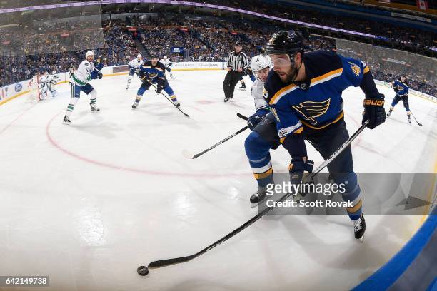 Robert Bortuzzo of the St. Louis Blues skates with the puck as Jayson Megna of the Vancouver Canucks defends on February 16, 2017 in St. Louis,...