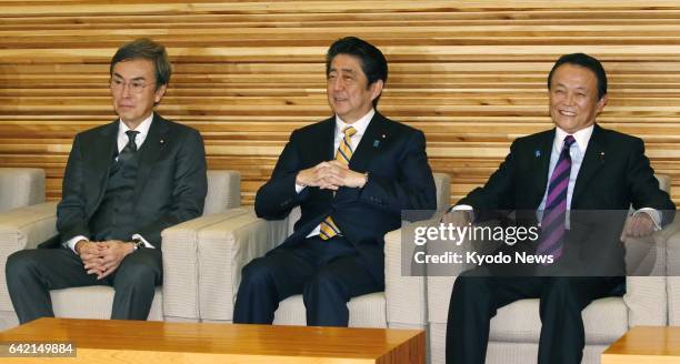 Japanese Prime Minister Shinzo Abe , Finance Minister Taro Aso and Nobuteru Ishihara, minister in charge of economic revitalization, attend a Cabinet...