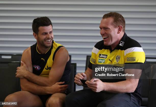 Trent Cotchin of the Tigers laughs with assistant coach Justin Leppitsch during the Richmond Tigers AFL Team Photo Day on February 17, 2017 at Punt...