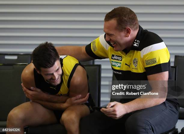 Trent Cotchin of the Tigers laughs with assistant coach Justin Leppitsch during the Richmond Tigers AFL Team Photo Day on February 17, 2017 at Punt...