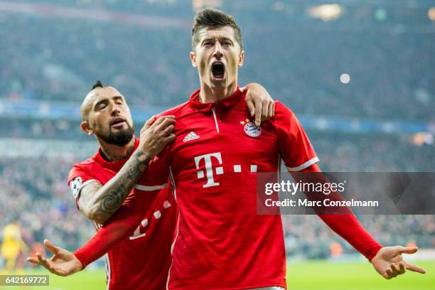 Robert Lewandowski of Bayern Munich celebrates after scoring his team's second goal together with Arturo Vidal during the UEFA Champions League Round...