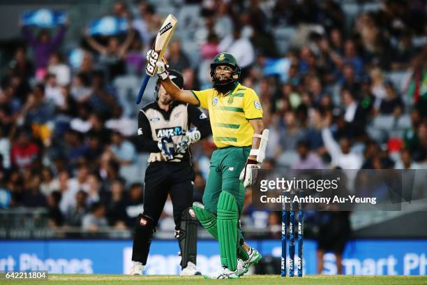 Hashim Amla of South Africa celebrates scoring a half century during the first International Twenty20 match between New Zealand and South Africa at...