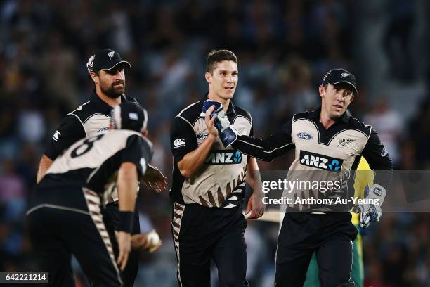 Ben Wheeler of New Zealand celebrates with teammate Luke Ronchi for the wicket of Hashim Amla of South Africa during the first International Twenty20...