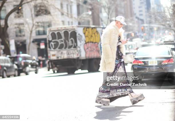 Guest is seen wearing a white fur, tie dye dress and raver style boots outside the Marc Jacobs show during New York Fashion Week: Women's Fall/Winter...