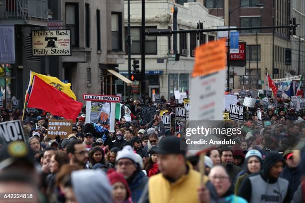 Thousands of demonstrators hold banners during a rally against US President Donald Trump's order and his recent policies regarding cracking down on...