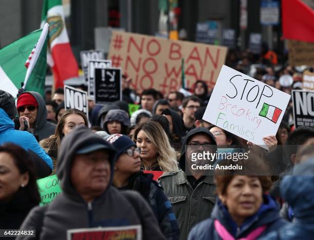 Thousands of demonstrators hold banners and flags during a rally against US President Donald Trump's order and his recent policies regarding cracking...