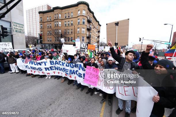 Thousands of demonstrators hold banners and shout slogans during a rally against US President Donald Trump's order and his recent policies regarding...