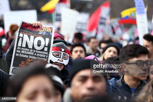 Demonstrator hold a placard during a rally against US President Donald Trump's order and his recent policies regarding cracking down on immigrants at...