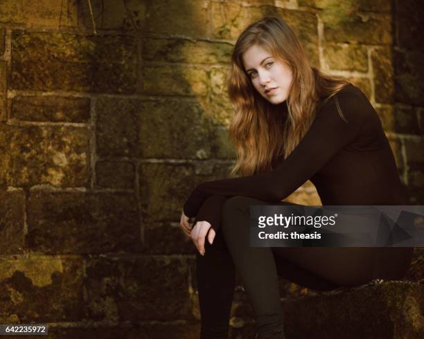 beautiful young woman in black - theasis stock pictures, royalty-free photos & images
