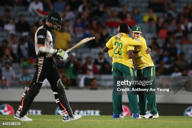 De Villiers of South Africa celebrates with teammates for the wicket of Mitchell Santner of New Zealand during the first International Twenty20 match...