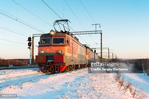 powerful electric locomotive leads freight train in sunset light - tank car stock pictures, royalty-free photos & images