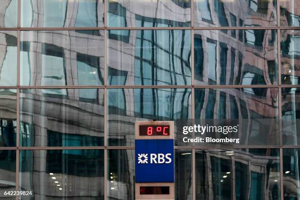Logo sits on a pillar, displaying the temperature in degrees Celsius, outside a Royal Bank of Scotland Group Plc head offices in London, U.K., on...
