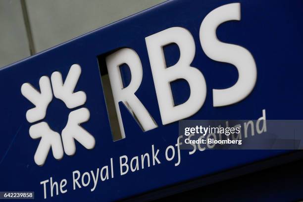 Damaged logo sits above an automated teller machine outside a Royal Bank of Scotland Group Plc bank branch in London, U.K., on Wednesday, Feb. 15,...