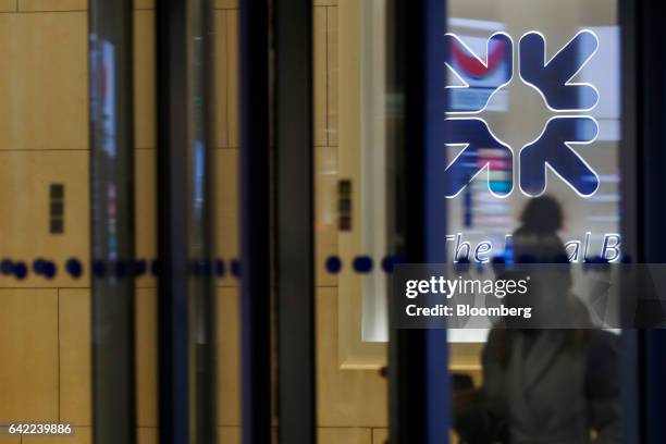An employee leaves the Royal Bank of Scotland Group Plc offices in London, U.K., on Wednesday, Feb. 15, 2017. RBS is preparing to cut more than 1...