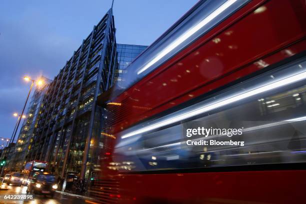 Bus leaves light trails as it passes the Royal Bank of Scotland Group Plc headquarters in London, U.K., on Wednesday, Feb. 15, 2017. RBS is preparing...
