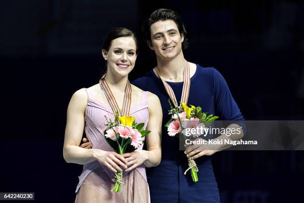 Gold medalists Tessa Virtue and Scott Moir of Canada pose on the podium during the medals ceremony of the Ice Dance in ISU Four Continents Figure...