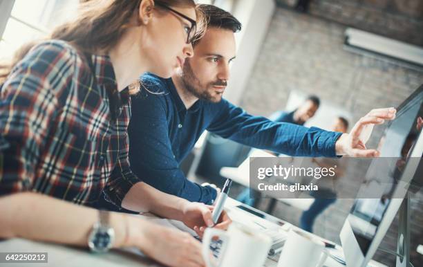 graphic designers at their studio. - desenhador-gráfico imagens e fotografias de stock