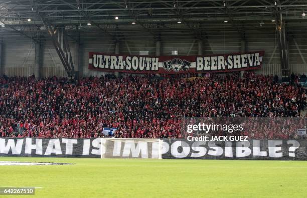 Hapoel Beer-Sheva supporters cheer at the end of the first leg of their UEFA Europa League football match between Hapoel Beer-Sheva and Besiktas, on...