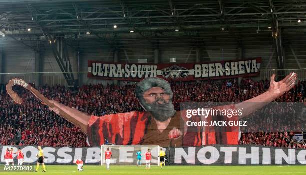 Hapoel Beer-Sheva supporters raise a large motif at the end of the first leg of their UEFA Europa League football match between Hapoel Beer-Sheva and...