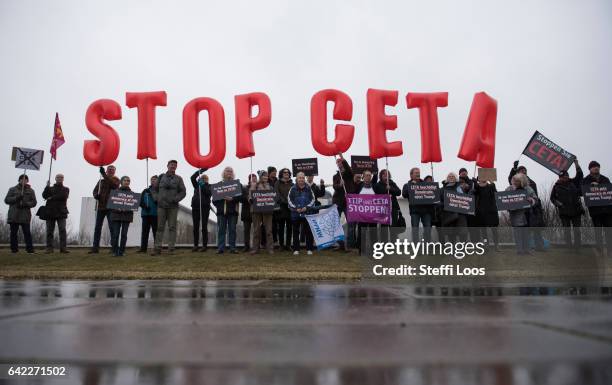 Activists protest against CETA trade agreement before a visit of Canada's Prime Minister Justin Trudeau in front of the chancellery on February 17,...
