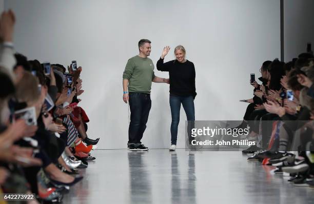 Fashion designers Rob Jones and Catherine Teatum on the runway after their show during the London Fashion Week February 2017 collections on February...