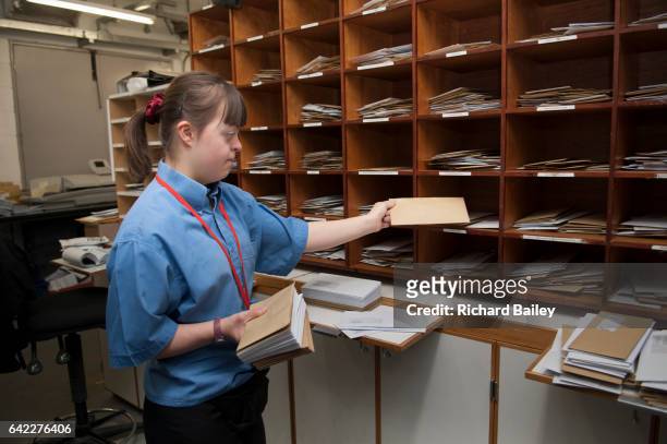 young lady with down syndrome at work as a porter in a hospital. - sortering bildbanksfoton och bilder