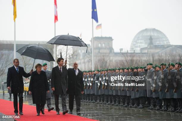 German Chancellor Angela Merkel welcomes Canadian Prime Minister Justin Trudeau with military honors in front of the Chancellery on February 17, 2017...