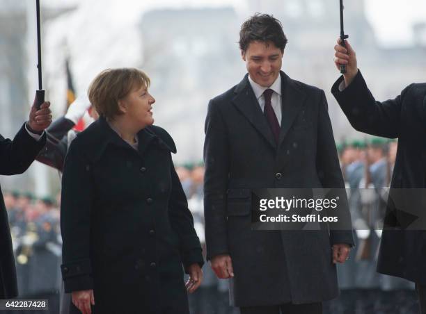 German Chancellor Angela Merkel welcomes Canadian Prime Minister Justin Trudeau with military honors in front of the Chancellery on February 17, 2017...