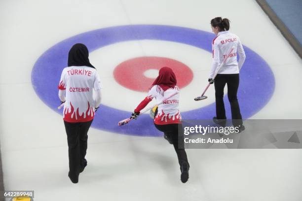 Hilal Nevruz , Berivan Polat and Zeynep Oztemir of Turkish National Girls' Curling Team compete against Polish National Girls' Curling Team during...