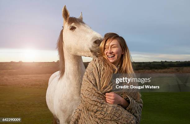 woman and horse on moorland at sunset. - equestrian animal stock pictures, royalty-free photos & images