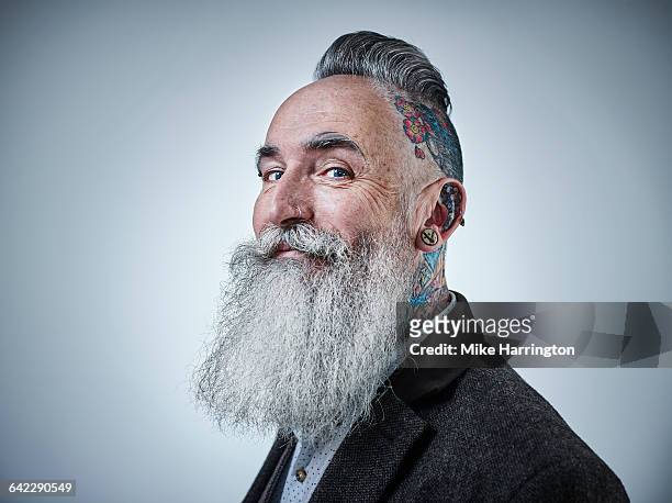 portrait of mature male with tattooed head - bunter mantel stock-fotos und bilder