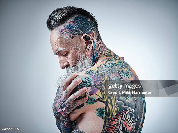 close up portrait of heavily tattooed male - back tattoo stock pictures, royalty-free photos & images