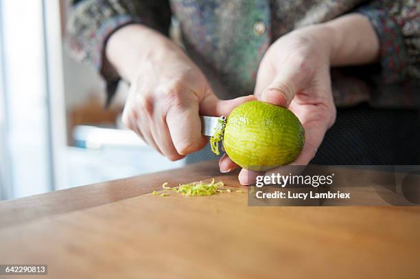 harvesting lime zest - scorza di limone foto e immagini stock