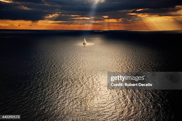 sailing boat sailing in the deserted ocean - verboten stockfoto's en -beelden