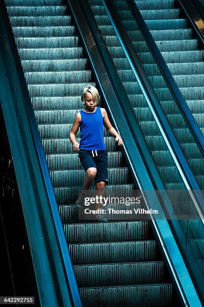 boy goes down the escalator - running up an escalator stock pictures, royalty-free photos & images