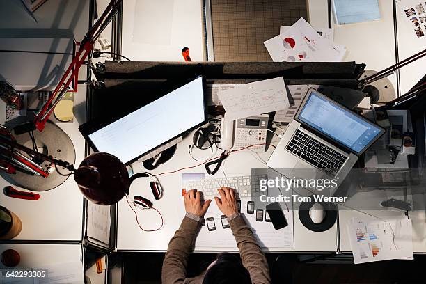 entrepreneur working late on his computer - messy work desk stock pictures, royalty-free photos & images