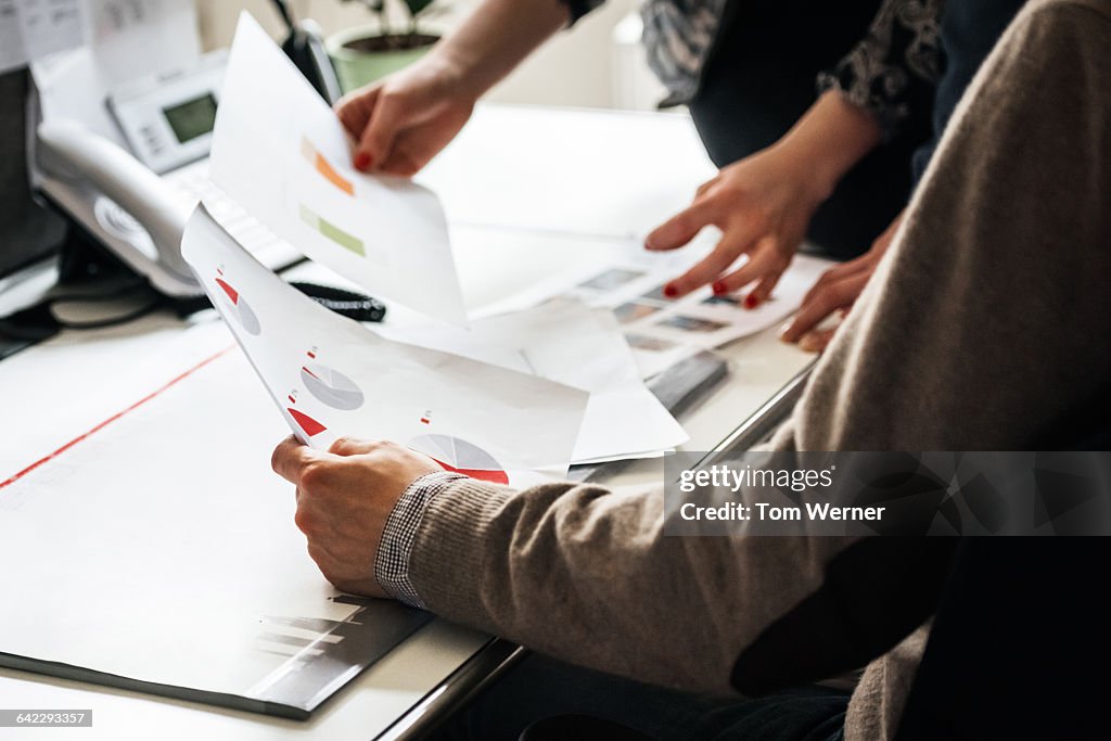 Business people's hands holding document