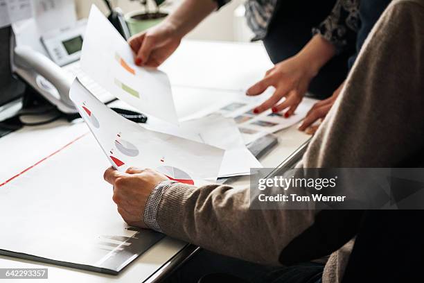 business people's hands holding document - comparison stockfoto's en -beelden